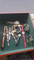 Overview of all watches showing different styles of strap including leather, metal link, chain, and bangle.
