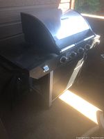 Full view of the Brinkmann gas grill showing front and side shelf.