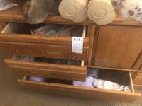 Three wooden drawers partially open showing neatly folded socks in various colors and types.
