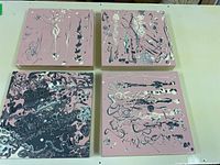 Four square boards with abstract acrylic paint on pink backgrounds