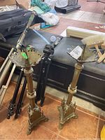 Full view of both brass candle holders showing height and design features