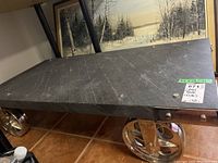 Top view showing textured slate surface with scratch marks and metal mounting discs