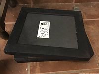 Photo showing stacked black wooden contact print frames with a label indicating three pieces 12.5x10.5