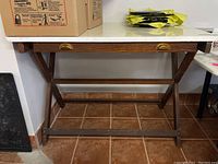 Front view of vintage drafting table with refinished top and drawer under the surface, showing overall design, materials, and condition.