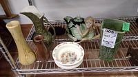 Full lot showing vases, teapot, Bunnykins bowl, McCoy pitcher on metal shelf