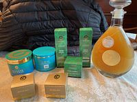 Photo of eight assorted unopened skincare products including jars, rectangular boxes and bottles from Perlier and Elizabeth Grant on table.