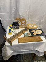Overview of vintage game items including cribbage boards, dominoes, playing cards, dice cup, and scoring board.
