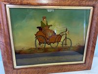 Vintage reverse glass painting of a steam car inside a birdseye maple frame, showing the entire artwork and frame.