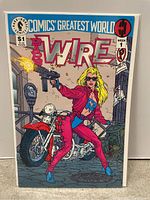 Front cover photo of Barb Wire comic book issue #1, showing character on motorcycle with guns.