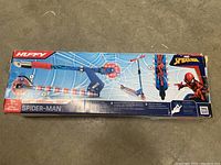 Box of Huffy Spider-Man scooter showing branding, LED lights feature, age recommendation and max weight
