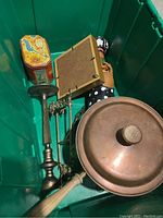 Various decor items including candlestick holder, framed item, tin container, and lidded dish