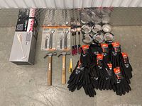Mixed lot of tools showing vacuum, wrenches, hammers, gloves, tape and screwdrivers