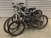 Three mountain/hybrid bicycles grouped together, front-left view