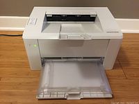 Front view of HP LaserJet Pro M102w printer with paper output tray extended.