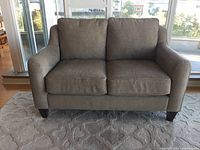 Front view of loveseat showing two-seat configuration and legs