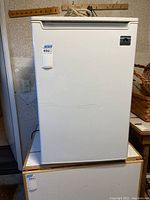 Front view of white Igloo mini freezer model FRF3230B with visible door and brand logo.