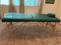Full side view of unfolded massage table