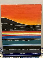Front view of the original vintage desert landscape painting showing the layered colored bands and orange-red sky.