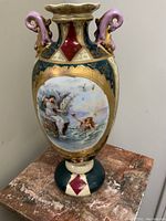 Full front view of vase showing overall shape, colors and decorative elements.