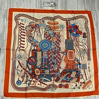 Full view of scarf with water bottle for scale showing overall pattern and border