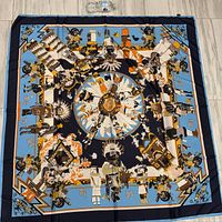 Full view of the large silk scarf laid flat showing entire design of Native American figures and geometric patterns
