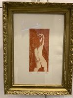 Overall view of the framed lithograph showing female nude print and frame wear.