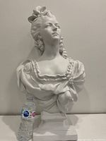 Full frontal view of the bust with scale reference (water bottle)