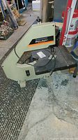Side view of the Black & Decker 12 inch band saw showing the full machine and work table.