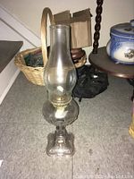 Full photo of the antique bullseye oil lamp showing glass chimney, wick holder and decorative base.