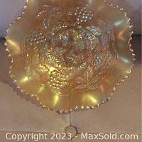 Top view showing the ruffled edge and grape/cable pattern in marigold carnival glass with no visible chips or cracks.