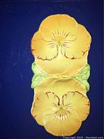 Top view of the double pansy trinket bon bon dish showing yellow pansy flowers and green leaf detailing