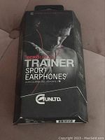 Front of sealed Ecko Unltd Trainer Sport Earphones box showing branding and product image with model wearing earphones.