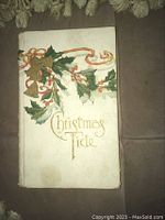 Front cover with Christmas holly and gold bells decoration and title 'Christmas Tide'