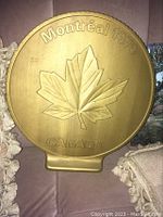 Front side showing embossed maple leaf with 'Montreal 1976 CANADA'.