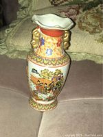 View of front side of small vintage hand painted Satsuma Japanese vase with detailed figures, floral patterns and gold accents