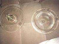 Top view of the etched glass platter with raised handle and the etched glass bowl showing detailed floral and leaf etching patterns.