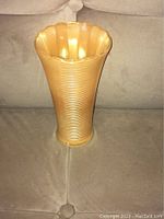 Front view of the peach lustre ribbed vase showing texture and shape