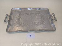 Image showing full rectangular aluminum tray with scalloped edges and decorative handles, highlighting overall shape and condition.
