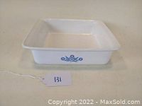 Front view of white square Corning Ware baking dish with blue cornflower pattern on side.
