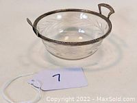 Clear etched glass bowl with sterling silver rim and handles showing decorative detailing and condition.