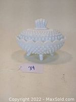 Front and side view of Fenton hobnail milk glass covered candy dish showing hobnail texture, scalloped rim, lid knob and three feet.