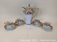 Full set displayed including hexagonal pot, four cups, and four matching saucers with floral patterns and gold trim.
