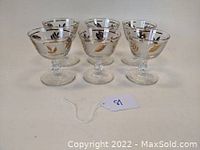Front view of three Libbey dessert dishes showing golden foliage pattern detail on clear glass.