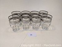 Eight Dorothy Thorpe inspired double old fashioned tumblers arranged in rows showing their shape and design with silver rim details.