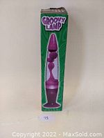 Full view of original Groovy Lamp box featuring an image of a purple lava lamp, green background and Groovy Lamp branding.