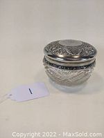 Front view of the Victorian cut glass jar with silver plated lid, showing embossing and monogram.