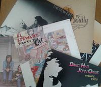 Photo showing LP covers including Al Stewart 'Year of the Cat', Daryl Hall & John Oates 'Private Eyes', and Neil Young 'The Stranger'.