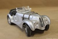 Front angle view of the 1/19 scale silver BMW 328 Roadster model showing detailed grille, headlights, and one front wheel.