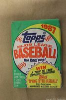 Close-up of a single unopened 1987 Topps Major League Baseball wax pack with green wrapper and colorful logo.