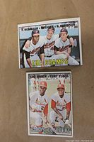 Four 1967 Topps baseball cards showing Orioles players Brooks Robinson, Frank Robinson, Hank Bauer, plus Lou Brock and Curt Flood in two group cards.